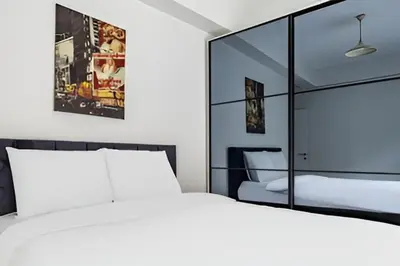 a bedroom with a white bed and a large mirror at HEARTH OF DOWNTOWN ,LUXURY 1 NEW APARTMENTs in Istanbul