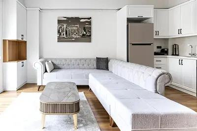 a white living room with a couch and a table at HEARTH OF DOWNTOWN ,LUXURY 1 NEW APARTMENTs in Istanbul