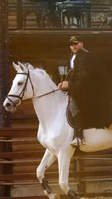 a man is riding a white horse at King Pansiyon in Karamandere