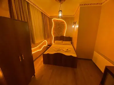 a small bedroom with a bed and a chair at Ulusoy Cafe in Istanbul