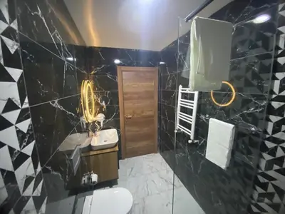 a bathroom with a black and white tiled wall at Ulusoy Cafe in Istanbul