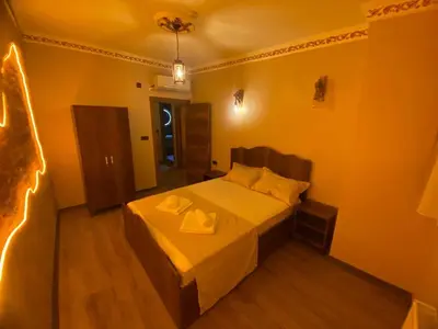 a bedroom with a bed with two towels on it at Ulusoy Cafe in Istanbul
