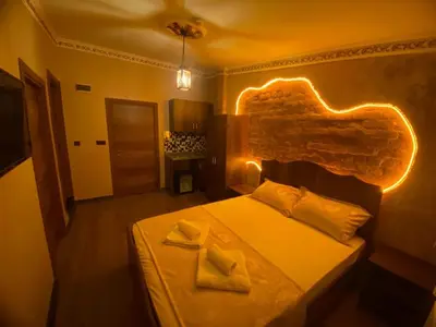 a bedroom with a bed with lights on it at Ulusoy Cafe in Istanbul
