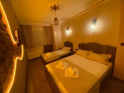 two beds in a hotel room with lights at Ulusoy Cafe in Istanbul