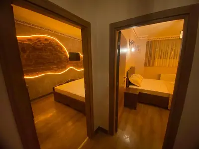 a door to a room with a bed and a window at Ulusoy Cafe in Istanbul