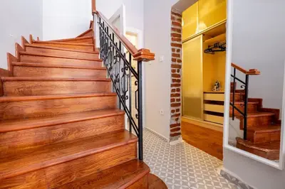 a staircase in a home with wood and metal railings at Spacious Dublex in Cihangir in Istanbul