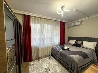 a bedroom with a bed and a window with red curtains at Şişli mado 9 2 3 in Istanbul