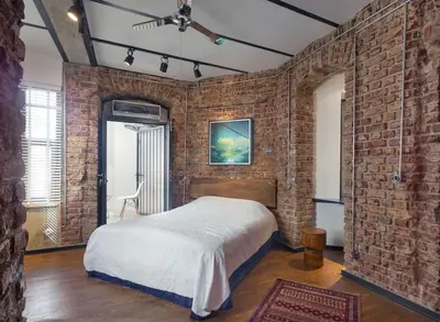a bedroom with a brick wall with a bed in it at Doctors Spacious Place in Istanbul