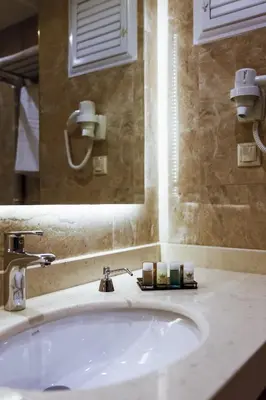 a bathroom with a sink and a mirror at Royal Hotel Inegol in Inegol