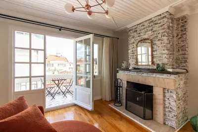 a living room with a stone fireplace and a balcony at Historic 2BR Gem in Downtown Sisli AC in All Rooms in Istanbul
