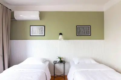 two beds in a room with green and white walls at Historic 2BR Gem in Downtown Sisli AC in All Rooms in Istanbul