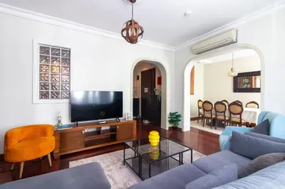 a living room with a couch and a tv at Tasteful & Spacious 3BR Haven in Trendy Şişli in Istanbul