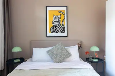 a bedroom with a bed with a picture of a cat at Tasteful & Spacious 3BR Haven in Trendy Şişli in Istanbul