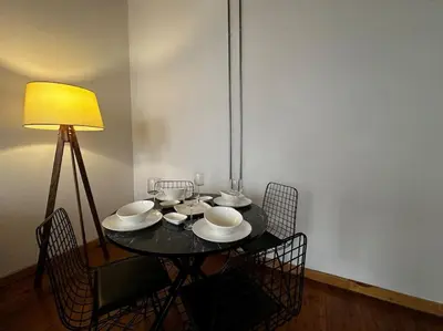 a black table with chairs and a lamp on it at Historical Flat in Galata - Tatar Beyi Street - TRA 2026 Award-Winner in Istanbul