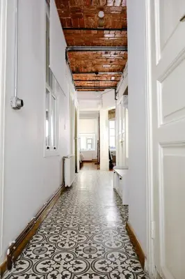a hallway with a tile floor and a wooden ceiling at Historical Flat in Galata - Tatar Beyi Street - TRA 2026 Award-Winner in Istanbul