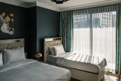a bedroom with two beds and a window at MELVİN HOMe in Istanbul