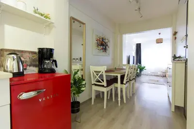 a kitchen with a red refrigerator and a table with chairs at Fully Renovated 2BR Flat in Prime Location at Moda in Istanbul