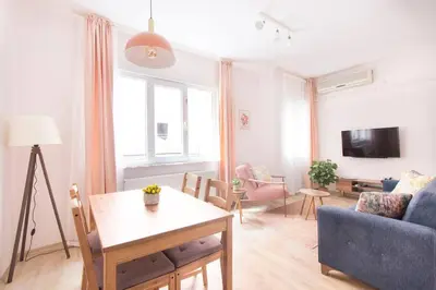 a living room with a blue couch and a table at Soft modern inspiring flat in the center of Moda in Istanbul