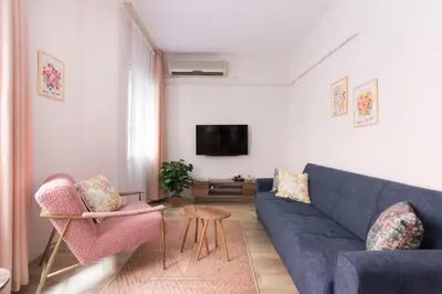 a living room with a blue couch and two chairs at Soft modern inspiring flat in the center of Moda in Istanbul