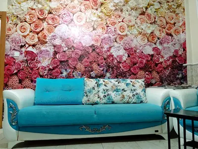 a mural of roses is shown behind a couch at Merkez İstanbul in Istanbul