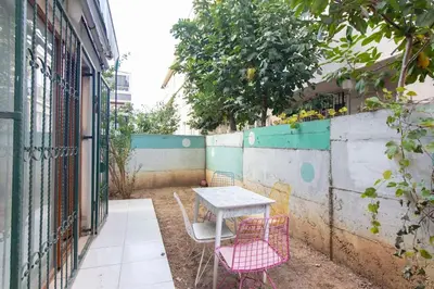 a table and two chairs sitting next to a fence at Cozy Modern 1BR w Patio New Building in Maltepe in Istanbul