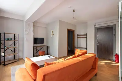 a living room with a couch and a table at Cozy Modern 1BR w Patio New Building in Maltepe in Istanbul