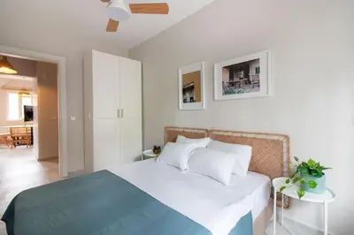 a bedroom with a bed with white walls and a ceiling at 2BR Flat W Modern Touches in Adalar