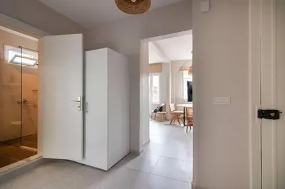a hallway with white walls and a glass door at 2BR Flat W Modern Touches in Adalar