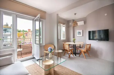 a living room with a table and a tv at 2BR Flat W Modern Touches in Adalar