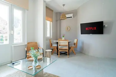 a living room with a table and a dining room at Designed and Modern 2BR Flat In Center Of Buyukada in Adalar