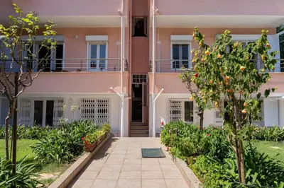 a pink house with a walkway in front of it at Designed and Modern 2BR Flat In Center Of Buyukada in Adalar
