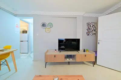 a living room with a television on a table at Taksim İstiklalin Kalbinde Konforlu Daire Netflix Wifi in Istanbul