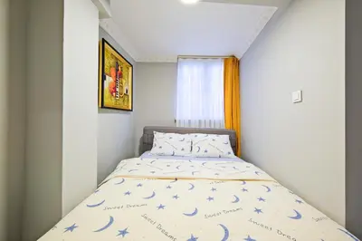 a small bedroom with a bed with blue stars on it at Taksim İstiklalin Kalbinde Konforlu Daire Netflix Wifi in Istanbul