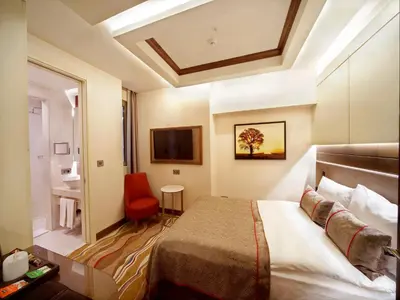 a hotel room with a bed and a bathroom at Grand Hotel de Pera in Istanbul