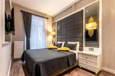 a bedroom with a bed with yellow pillows at Grand Hotel de Pera in Istanbul