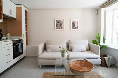 a living room with a couch and a table at 2BR Designed Flat In The Center of Buyukada in Adalar