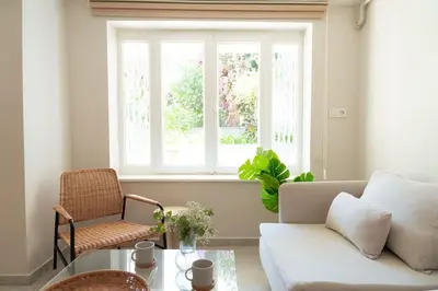 a living room with a couch and a window at Modern and Designed 2BR W Garden in Adalar