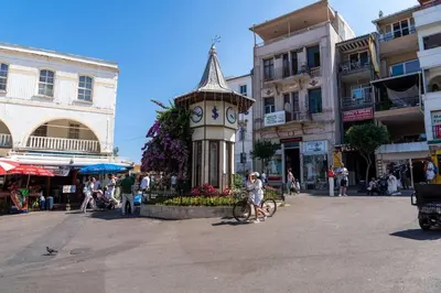 a clock tower in the middle of a street at Modern and Designed 2BR W Garden in Adalar