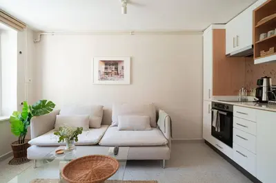 a living room with a white couch and a table at Modern and Designed 2BR W Garden in Adalar