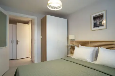 a bedroom with a bed and a chandelier at Modern and Designed 2BR W Garden in Adalar