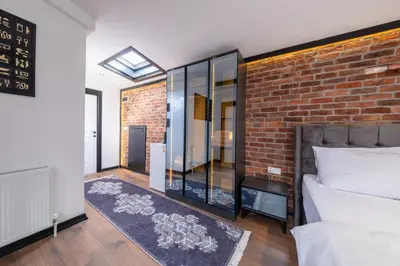 a bedroom with a brick wall and a bed and a window at Hexa Apartments Sisli in Istanbul