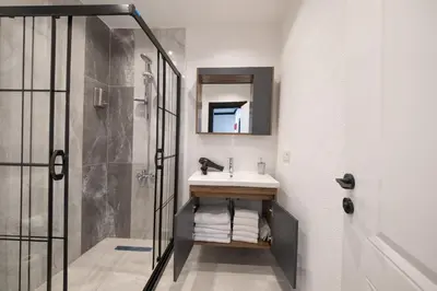 a bathroom with a sink and a shower at Hexa Apartments Sisli in Istanbul