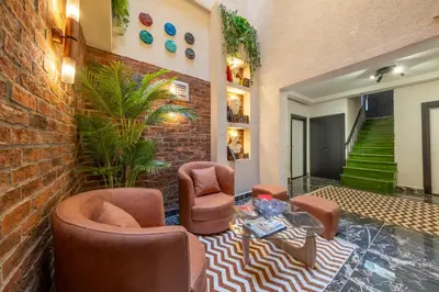 a living room with chairs and a brick wall at Hexa Apartments Sisli in Istanbul