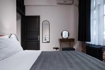 a bedroom with a bed and a mirror and a window at Spacious and Stylish 3BR w Private Garden in Istanbul