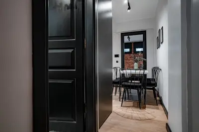 a black door leading into a dining room with a table at Spacious and Stylish 3BR w Private Garden in Istanbul