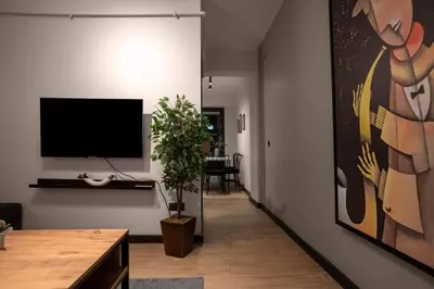 a living room with a flat screen tv on a wall at Spacious and Stylish 3BR w Private Garden in Istanbul