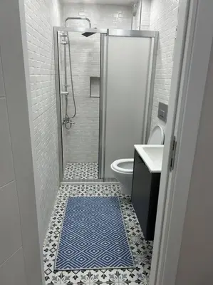 a bathroom with a shower and a blue rug on the floor at Üsküdar - Venüs home - Sakin Konaklama in Istanbul