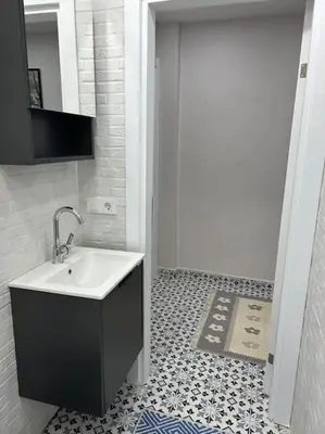 a bathroom with a white sink and a tile floor at Üsküdar - Venüs home - Sakin Konaklama in Istanbul