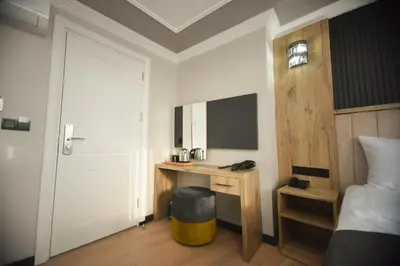 a bedroom with a desk and a bed and a door at Alessia Old City in Istanbul