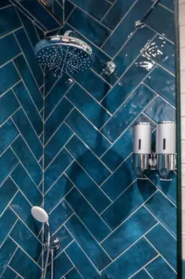 a bathroom with a shower with blue tiles at Şişli Family Time Suites in Istanbul